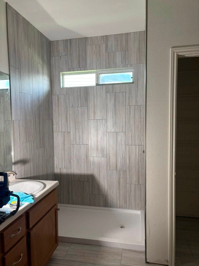 Finished tiled shower stall with new shower pan and vanity